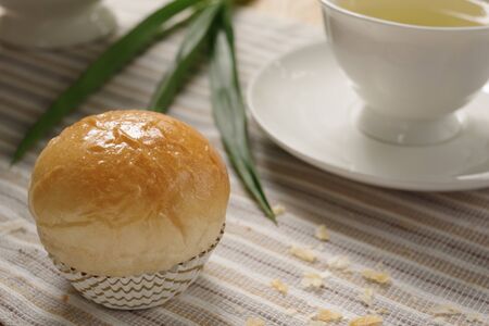 A delicious homemade pandan custard bread with earl grey in the afternoon tea.の写真素材