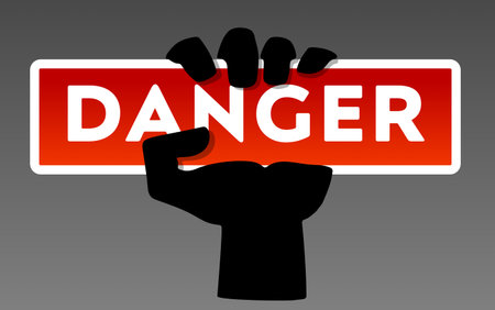 Danger warning sign with hand holding board