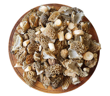 Lots of sliced spring mushrooms on a round plate. An isolated object. Ingredients for cooking. Cook from low-calorie foods. Weight loss.の写真素材