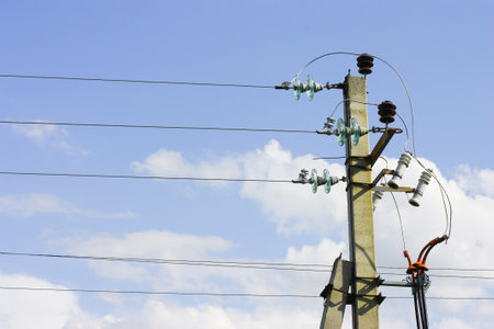 Electric poles with wires against the sky with clouds. The idea of providing electricity to the...