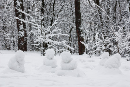 Figures made of snow in a forest clearing. Winter landscape. A lot of snow around. High quality...
