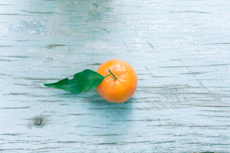 Fresh tangerine on a blue wooden tableの写真素材