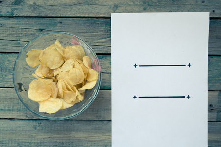 Potato chips with a sheet of paperの写真素材