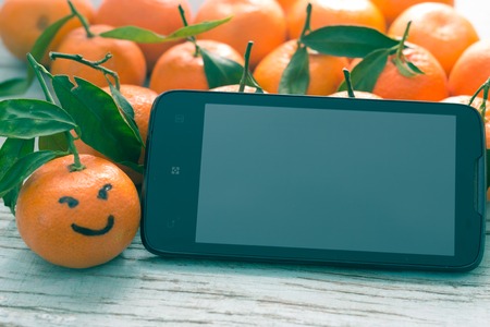 Fresh tangerines in a blue wooden board.の写真素材