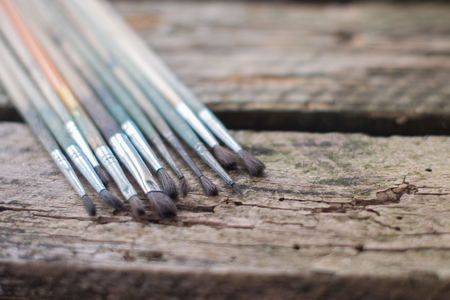 Paint Brushes on the old wooden backgroundの写真素材