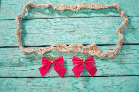 Frame made of twine in the old blue wooden boardsの写真素材