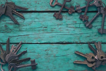 Old keys on a green wooden tableの写真素材