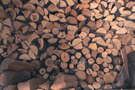 A stack of firewood stacked in the old barnの写真素材