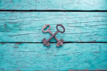 Old rusty keys on blue wooden boards.の写真素材