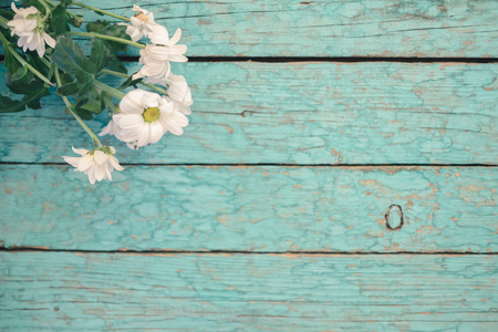 Fresh flowers of chrysanthemums on old wooden tableの写真素材