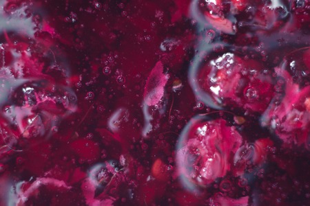 Macro of raspberry jam on a plateの写真素材