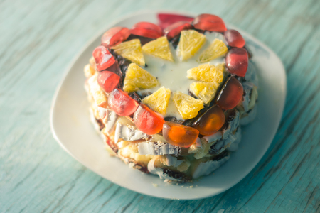 Homemade cake on a platter on a wooden boardの写真素材