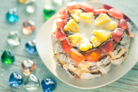 Homemade cake on a platter on a wooden boardの写真素材