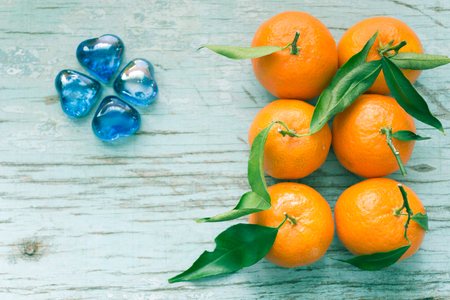 Fresh tangerines in a blue wooden board.の写真素材