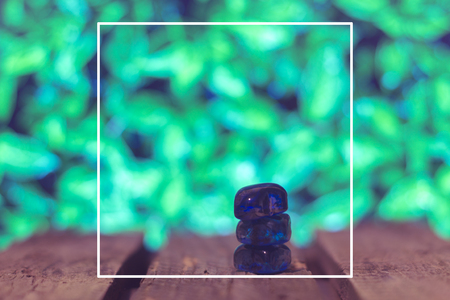 Wooden boards on a green spring background blurred leaves in the frameの写真素材