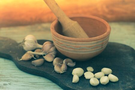 Spices and garlic on a wooden background.の写真素材