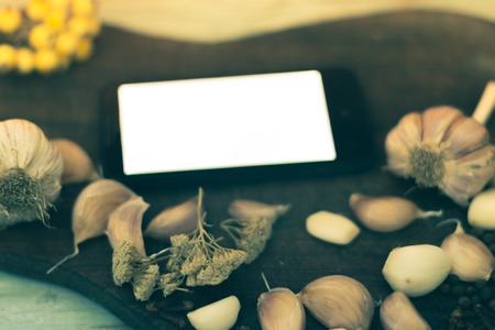 Mobile phone with white screen on table with spices.の写真素材