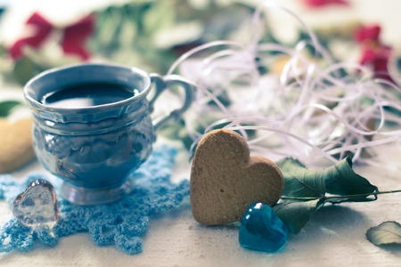cup of coffee and biscuit on a white wooden boardsの写真素材