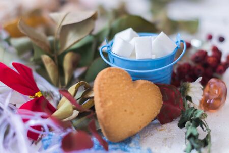 A small bucket with sugar on a plate with cookiesの写真素材