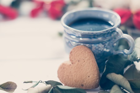 cup of coffee with cookies on a white background with ribbons.の写真素材