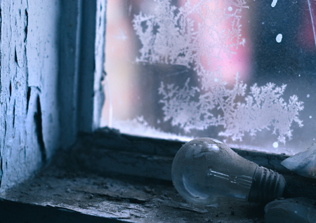 The old lamp in the dust on a windowsillの写真素材