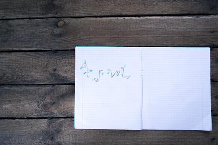 Notebook on a wooden background with seashells.の写真素材