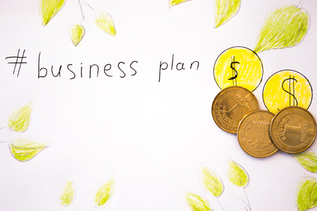 Business plan inscription with coins.の写真素材