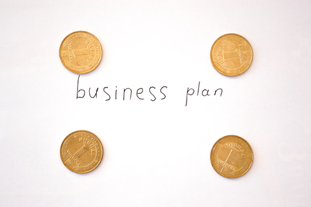 Business plan inscription with coins.の写真素材