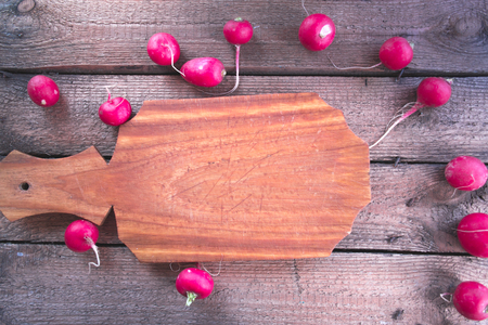 Still life of a cucumber radish on a wooden backgroundの写真素材