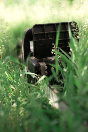 Power saw on green grass on blur backgroundの写真素材