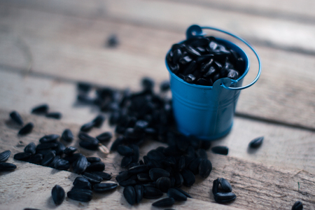 Seeds on a wooden grain table with a blurred backgroundの写真素材