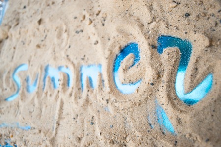 The inscription on the sand of the sunny summer beachの写真素材