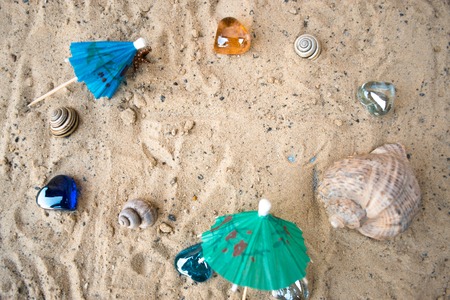 Cocktail umbrellas on the sand of a sunny beachの写真素材