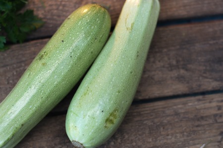 Fresh zucchini on a wooden old background with vegetablesの写真素材