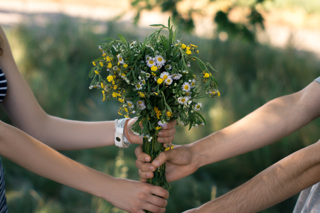 Surprise for girl gift flowers young surprised girl in the parkの写真素材