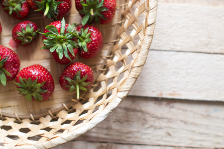 Fresh juicy strawberries on a wooden boardの写真素材