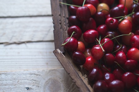 Cherry berries are fresh on a wooden background. Concept of healthの写真素材