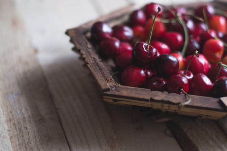 Cherry berries are fresh on a wooden background. Concept of healthの写真素材