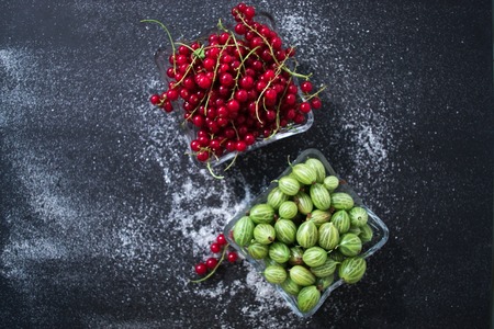 Summer fresh berries still life on a black background in a dishの写真素材