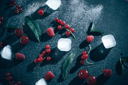 Fresh berries with ice on a black background