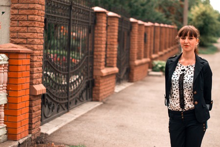Business lady in a business suit on a street with a blurred backgroundの写真素材