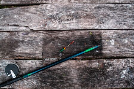 Fishing tackle, rod on a wooden background