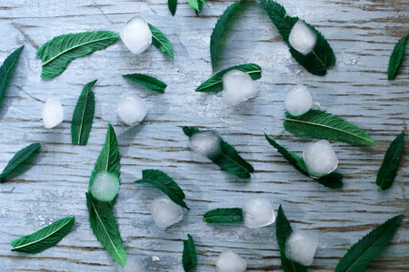 Natural ice on a blue wooden background