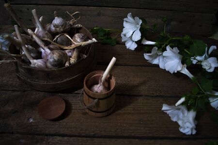Harvest of garlic on a wooden old backgroundの写真素材
