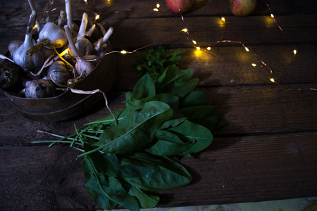 Garlic with apples on a wooden background
