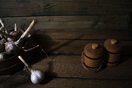 Harvest of garlic on a wooden old backgroundの写真素材