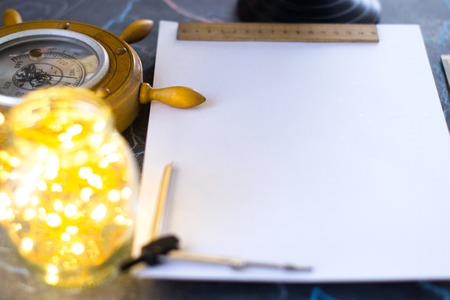 Barometer on a background of a white sheet of paper with lights in a glass jarの写真素材