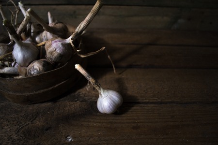 Harvest of garlic on a wooden old backgroundの写真素材
