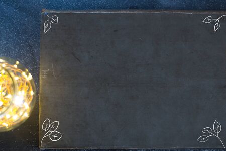 Dark background of an old book on a matte background with lights