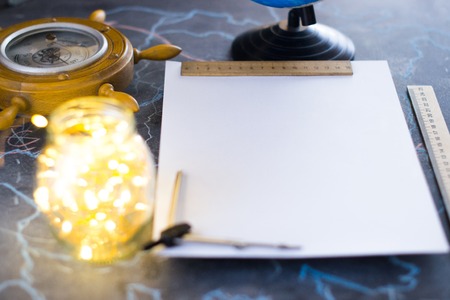 Barometer on a background of a white sheet of paper with lights in a glass jarの写真素材